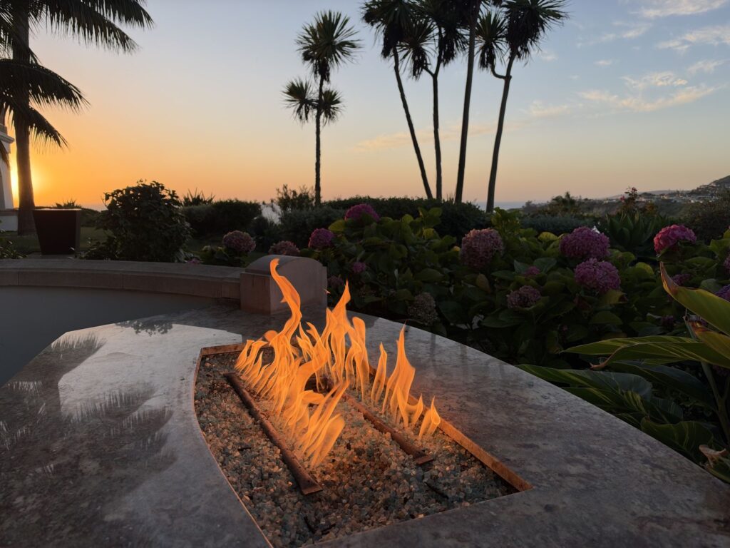 Private patio fire pit at sunset with palm trees and hydrangeas, Ritz-Carlton Laguna Niguel