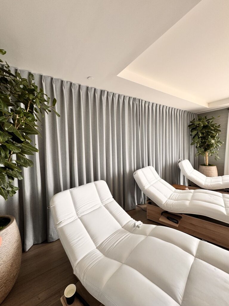Row of white heated loungers in the Terranea spa relaxation lounge
