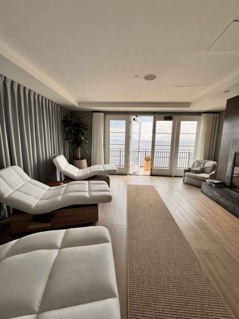 The relaxation lounge at The Spa at Terranea with white loungers and doors open to an ocean-view balcony