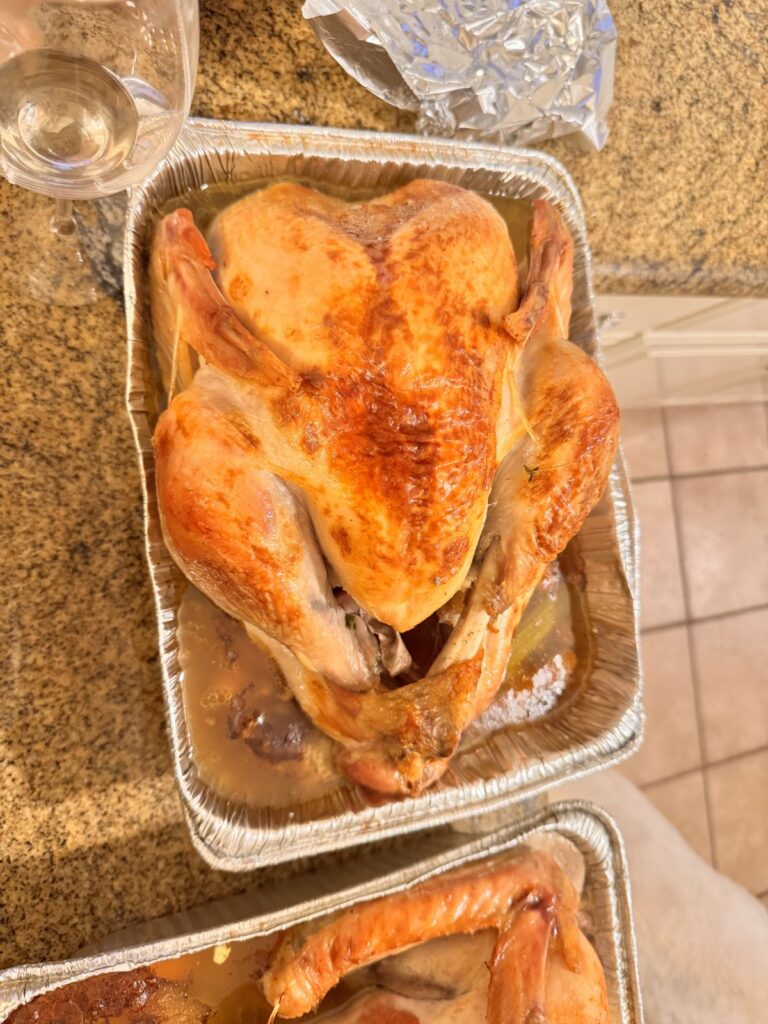 Roast turkey in a foil pan on the kitchen counter on Thanksgiving