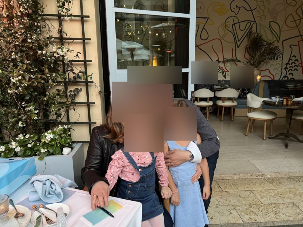 Our family at an outdoor table at The Terrace, faces blurred