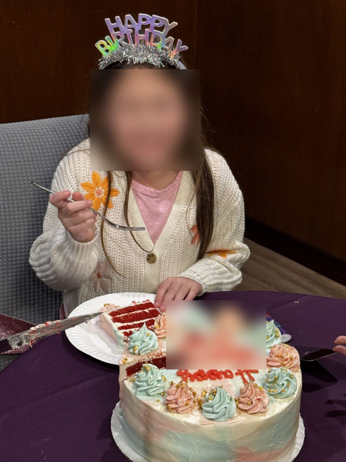 Birthday girl in a tiara with a red velvet SusieCakes birthday cake