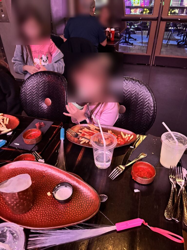 Two girls at dinner with a chocolate-dipped milkshake at The Toothsome Chocolate Emporium