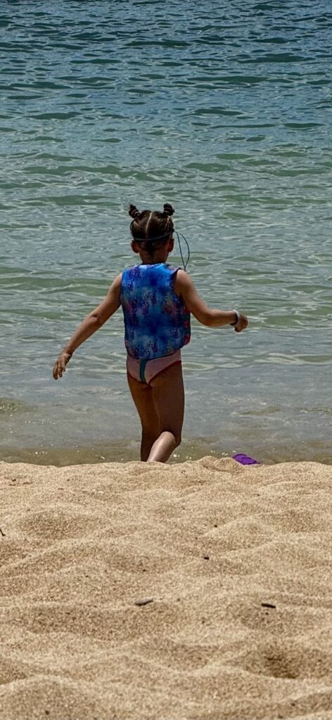 Child walking into the water at Kuilima Cove, Turtle Bay